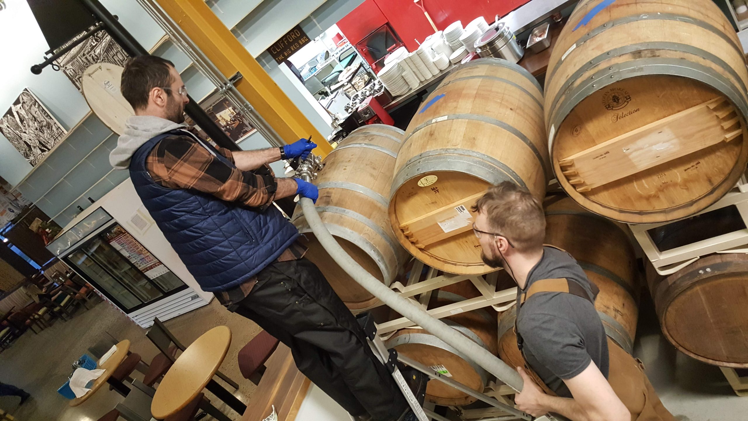 Charles and Tyler Fill Wine Barrel Prairie Dog Brewing's Pastrami on Rye Sandwich with side fries.