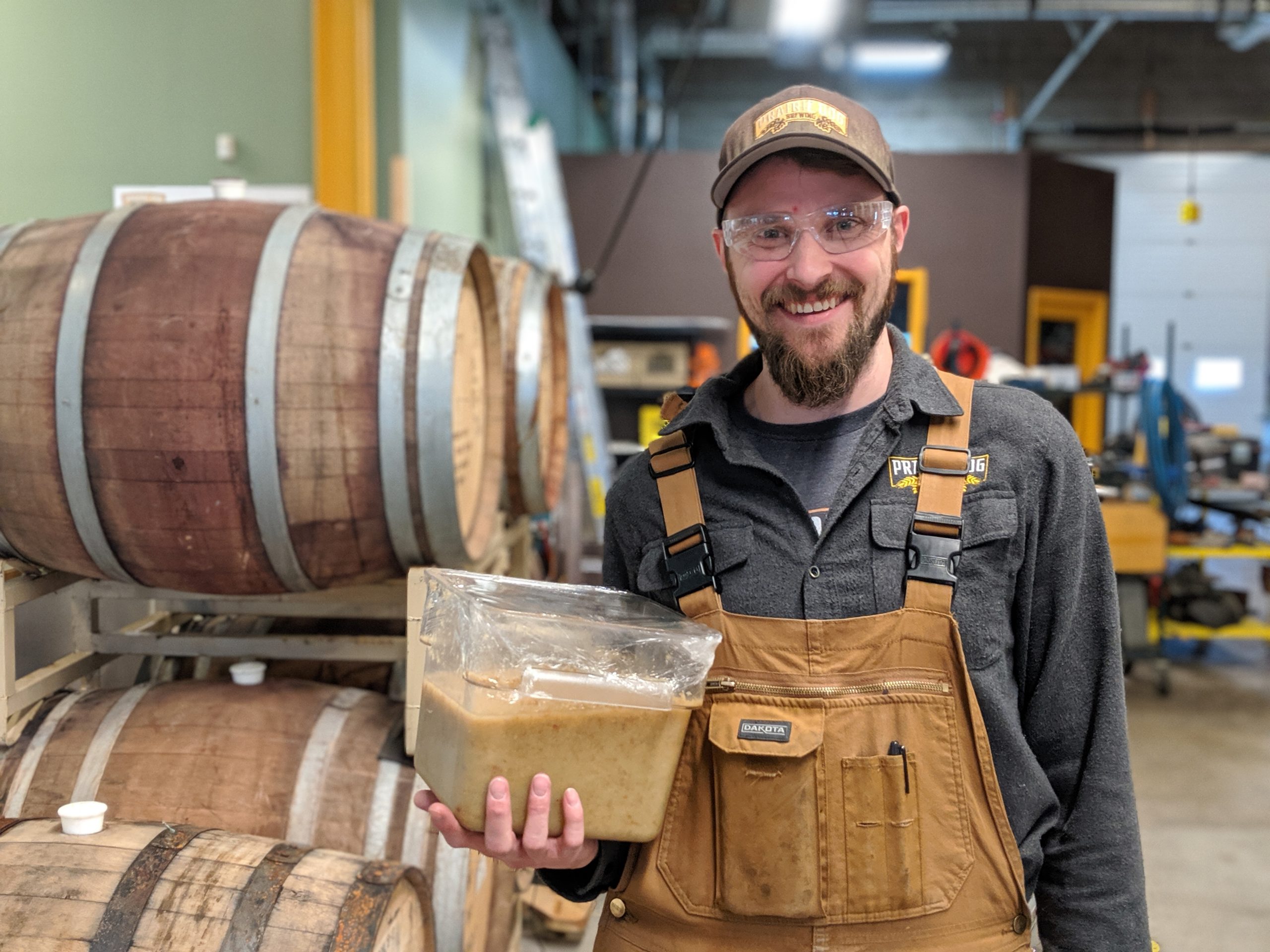 Founder Tyler works with blended ginger root in our brewery.