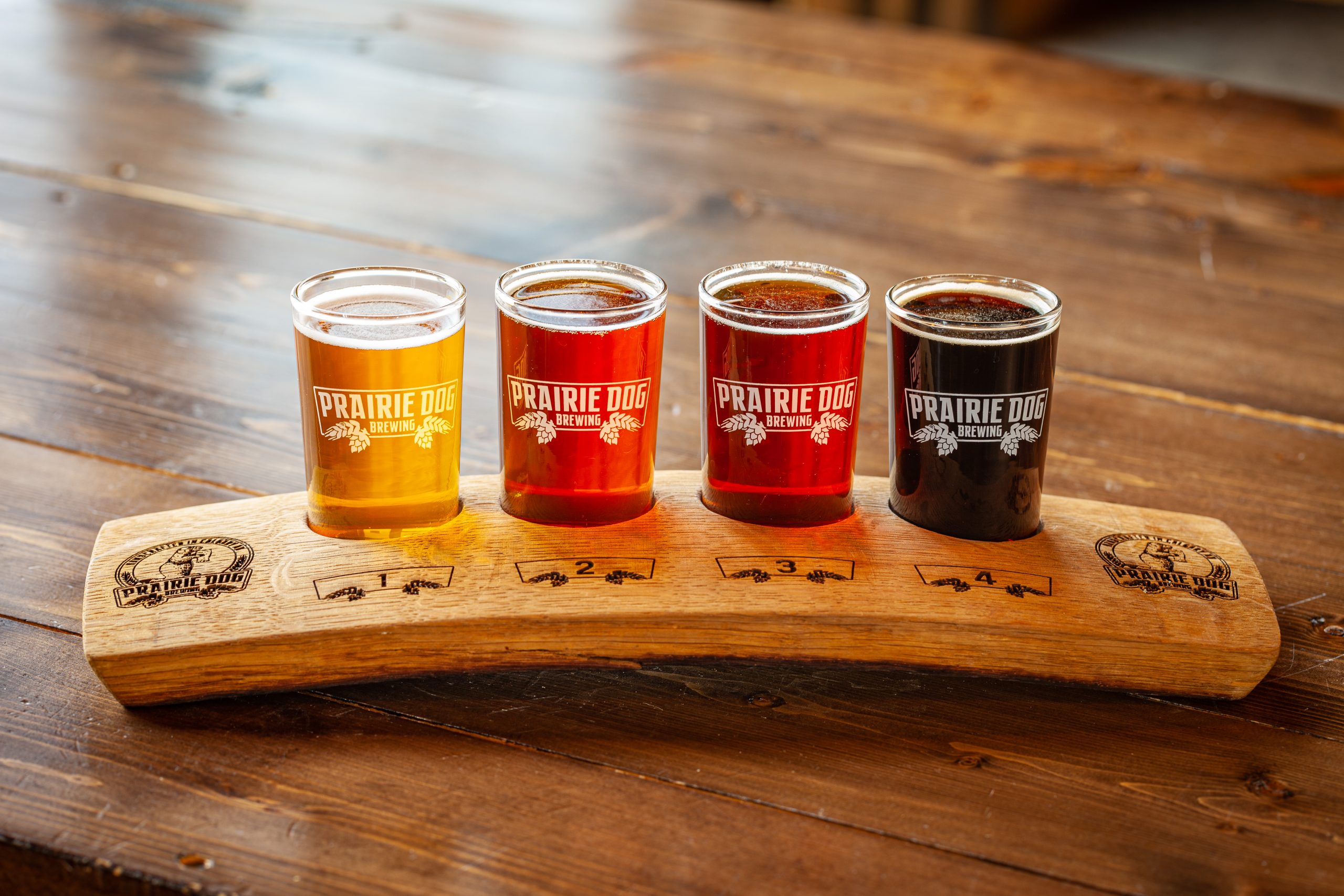 A Prairie Dog Brewing flight of four beers on one of our oak stave branded flight paddles.