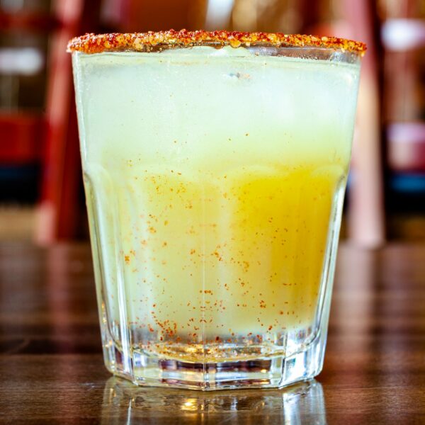 Chili Margarita coktail with 1oz Milagro tequila, lime, chili pepper syrup and a spicy house-made salt rim