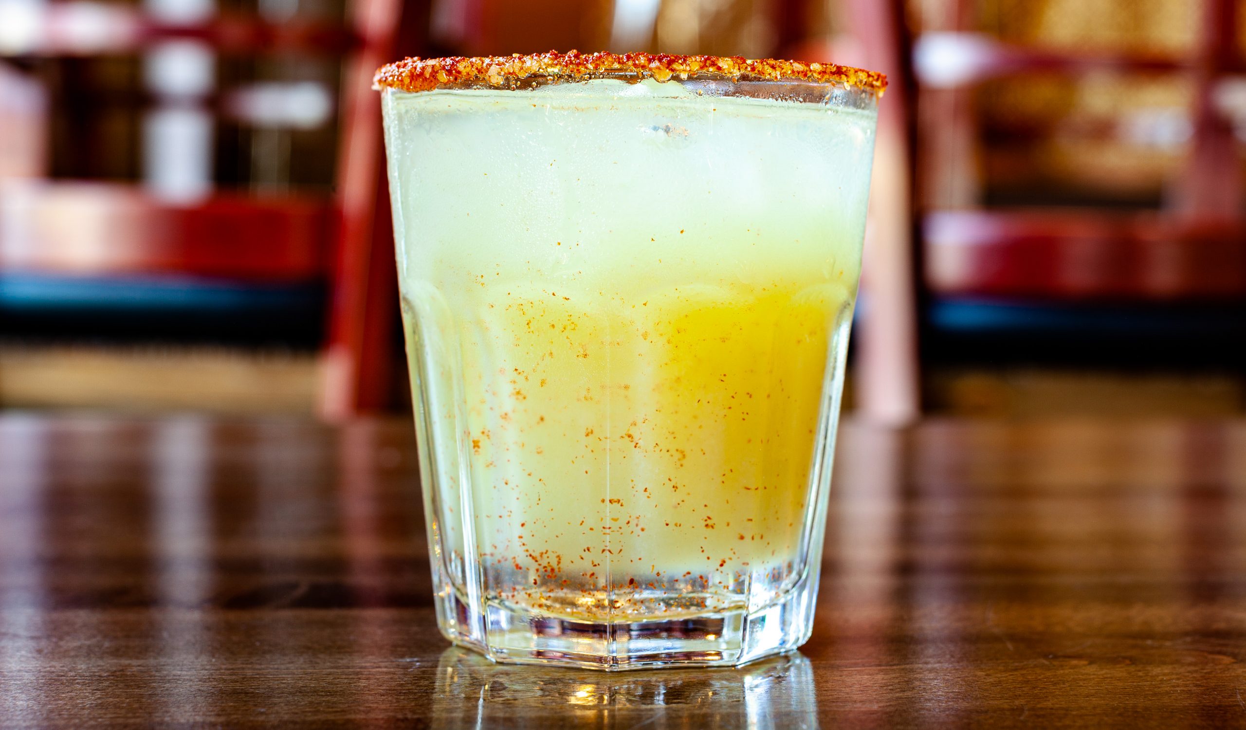 Chili Margarita coktail with 1oz Milagro tequila, lime, chili pepper syrup and a spicy house-made salt rim