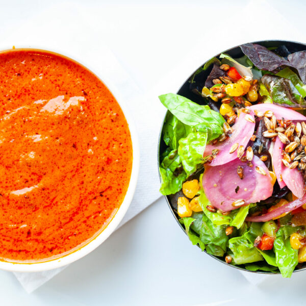 Tasty soup and salad combo meal on a white plate.