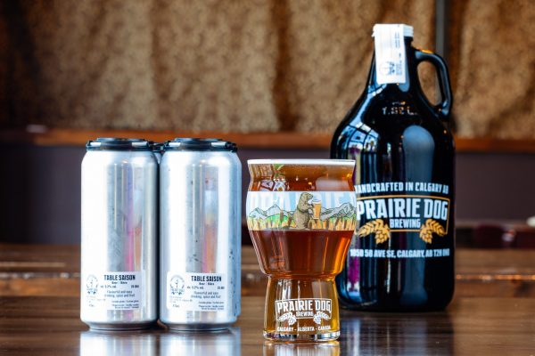 Prairie Dog Brewing's Table Saison in a 16oz glass, 473mL cans and 64oz growler
