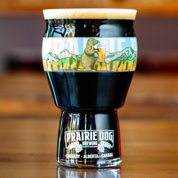 Prairie Dog Brewing's Uncle Eddie's Stubborn (Oatmeal) Stout in a branded 16-oz US pint glass.