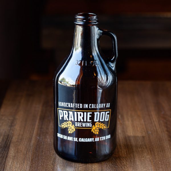 32-oz Prairie Dog Brewing branded glass howler jug for beer off-sales.