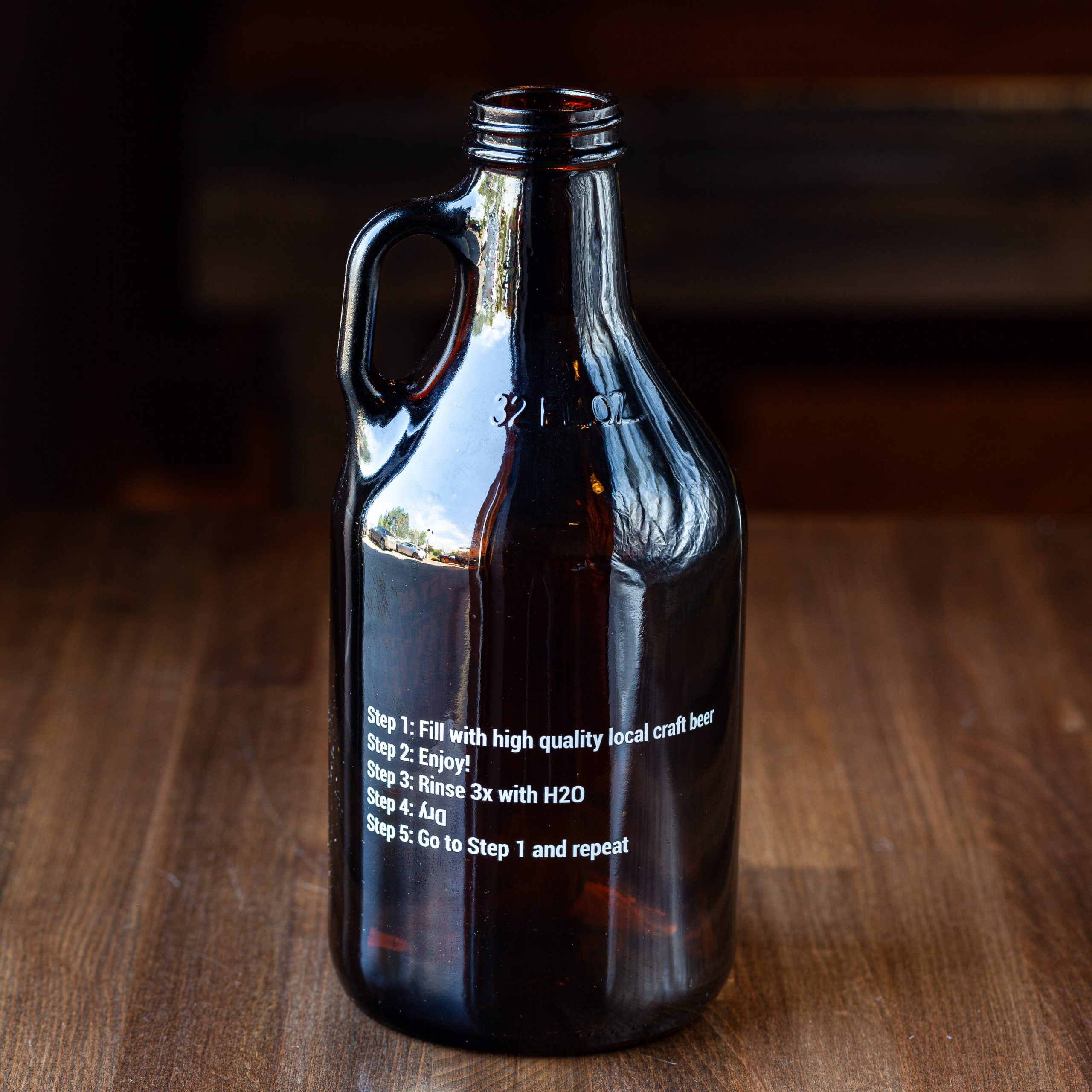 Rear side of 32-oz Prairie Dog Brewing branded glass howler jug for beer off-sales.