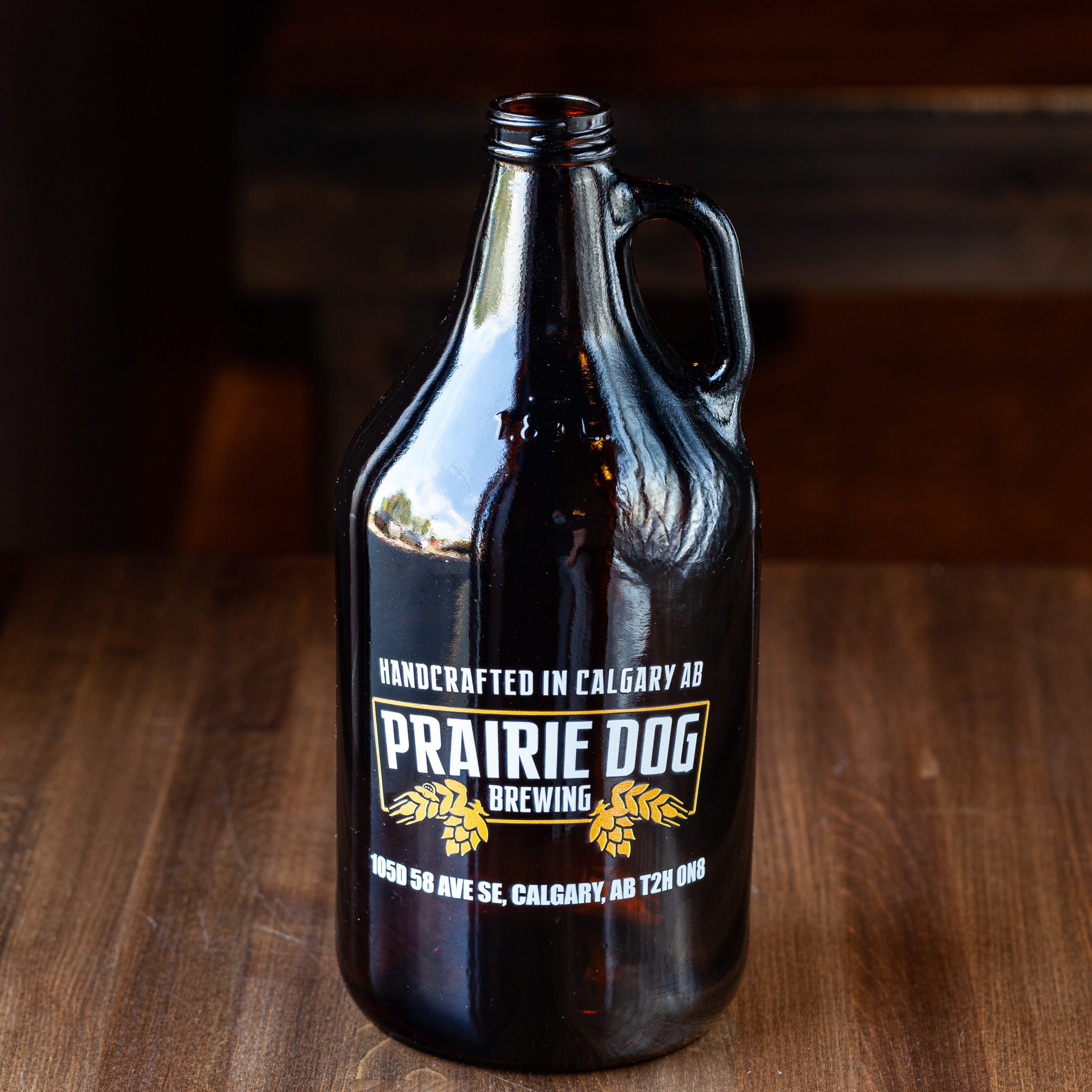 64-oz Prairie Dog Brewing branded glass growler jug for beer off-sales.
