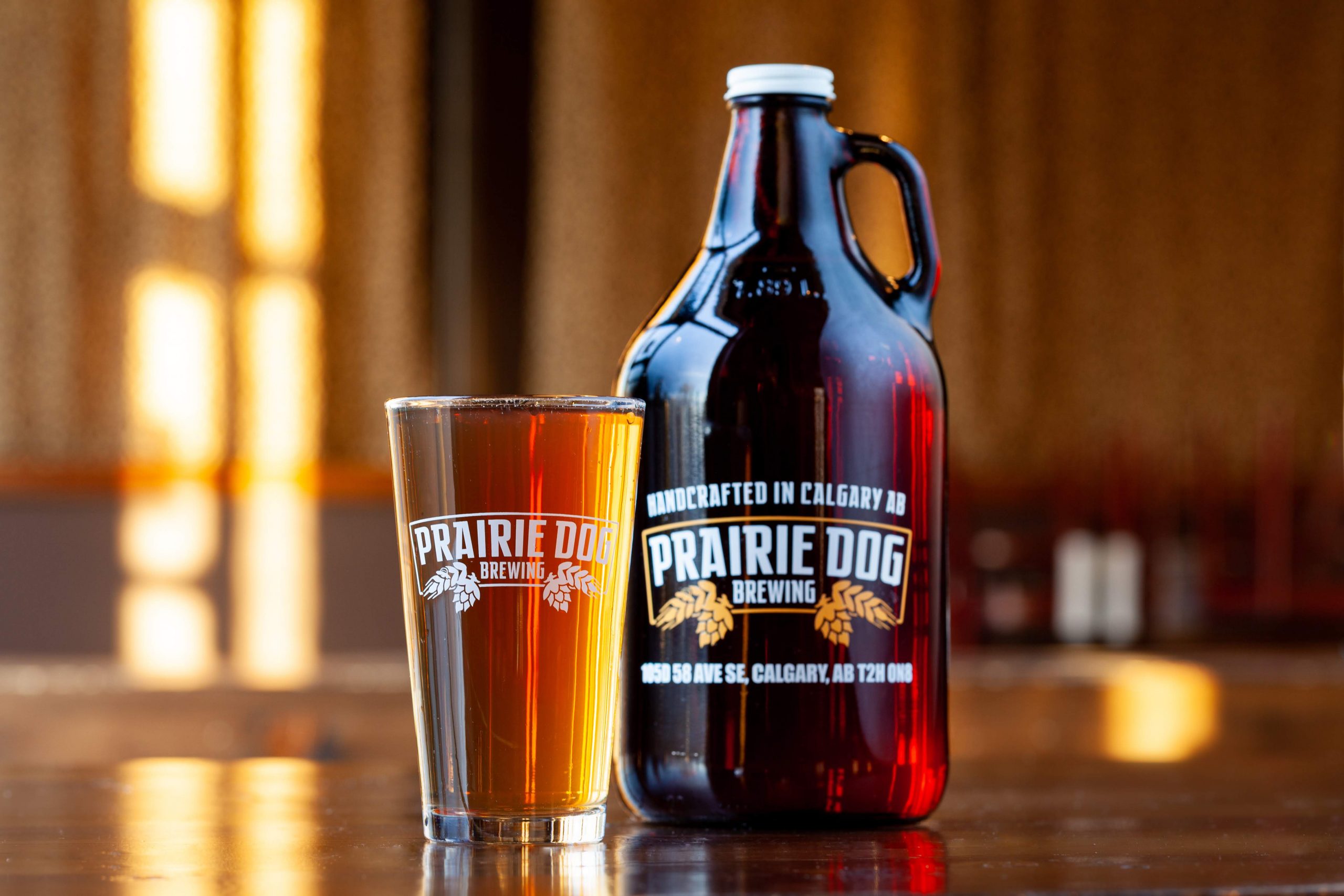 Sunrise Prelude Saison pint glass and Prairie Dog branded growler jug
