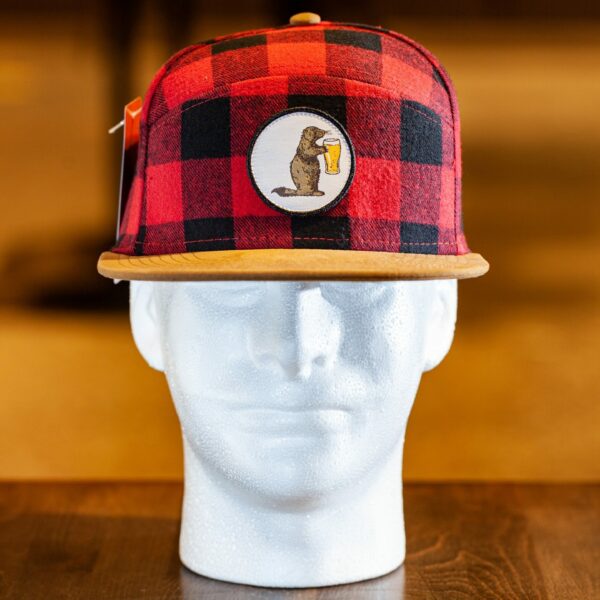 A Prairie Dog Brewing branded red and black Buffalo-check (plaid) hat, made by Pukka. The hat features our mascot Alby on a round embroidered button. Brown suede brim with snap-back.