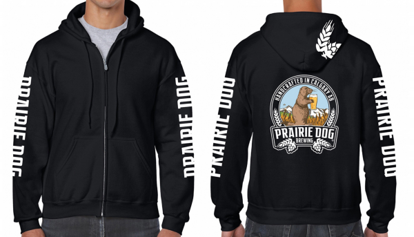 A person wearing a black zip-up hoodie that has Prairie Dog written down the arms and the Prairie Dog Brewing badge on the back.