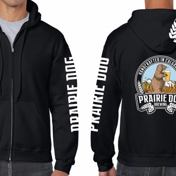 A person wearing a black zip-up hoodie that has Prairie Dog written down the arms and the Prairie Dog Brewing badge on the back.