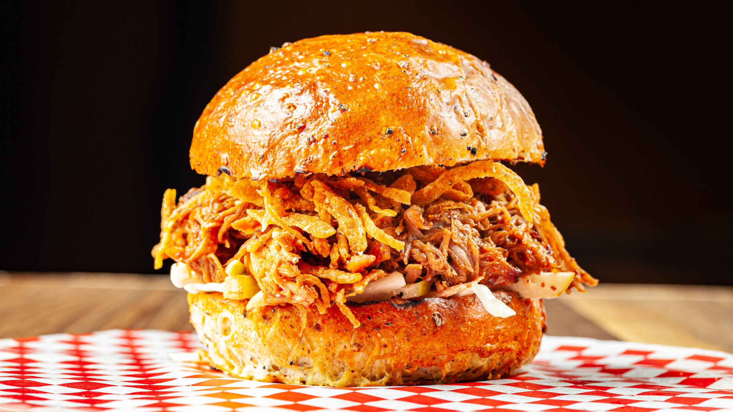 Prairie Dog Brewing's Alberta Red Pulled Pork Sandwich with pulled pork, barbecue sauce, apple slaw and crispy onions.