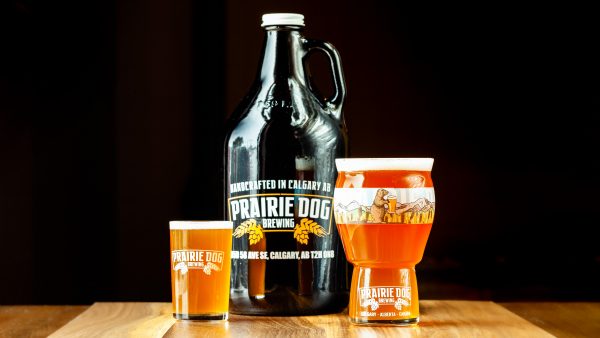 Prairie Dog Brewing's Boots Up Belgian-style IPA, a celebration of International Women's Day, in multiple formats including 5oz and 16oz draft pours, and a 64oz growler jug.