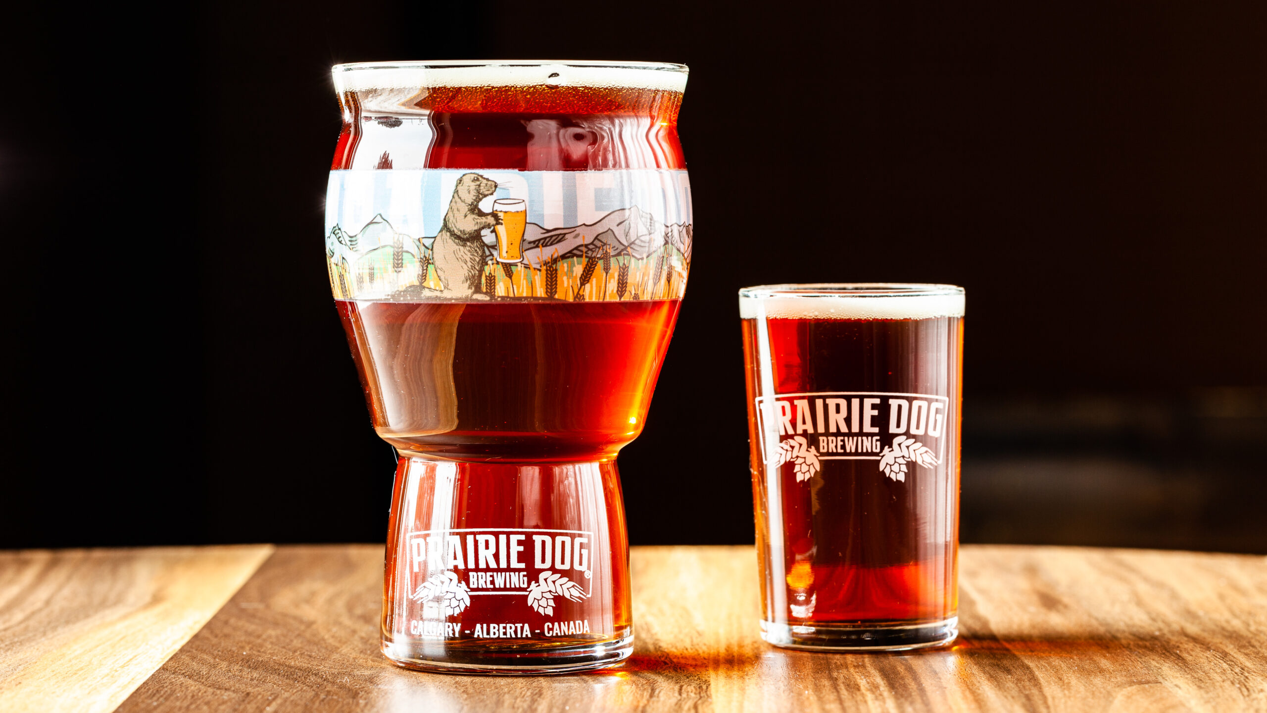 Prairie Dog Brewing's Supinator Doppelbock in 16oz and 5oz draft pour glasses.