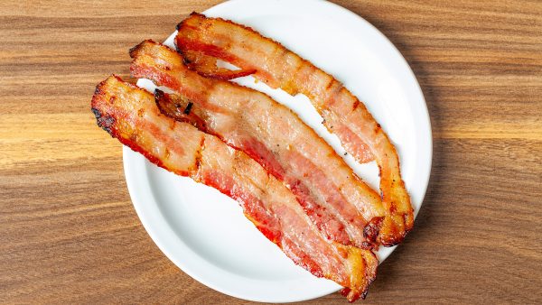 Three slices of Prairie Dog Brewing thick-cut smoked bacon served as an add-on item.