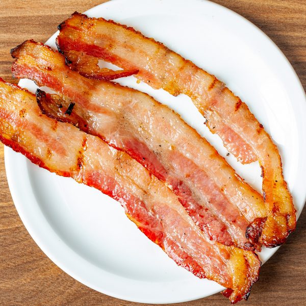 Three slices of Prairie Dog Brewing thick-cut smoked bacon served as an add-on item.