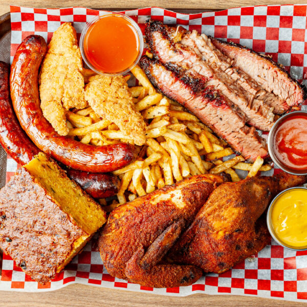 Prairie Dog Brewing's Coterie BBQ platter with chicken, brisket, chorizo sausage, chicken tenders and two sides and sauces.