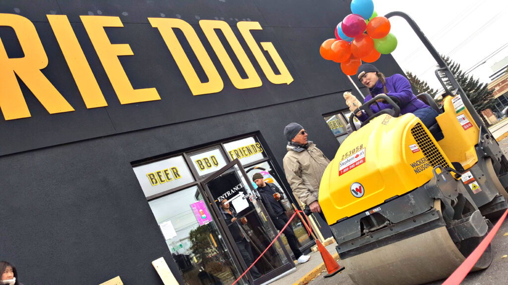 Prairie Dog Brewing founder Laura Coles rides a small steam roller in our parking lot for the 