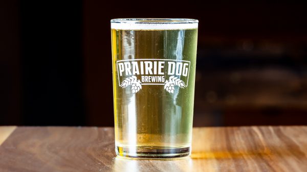 A 150mL draft pour of Uncommon Cider in a Prairie Dog Brewing branded beer glass.