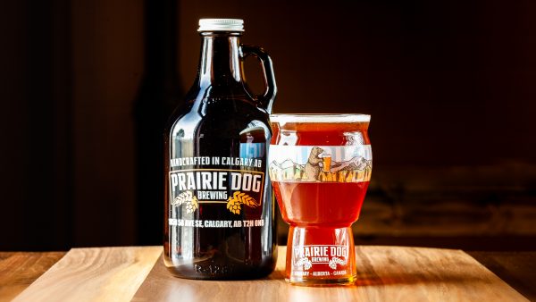 Prairie Dog Brewing's Prairie Lands Lager in a 946mL howler jug and 473mL draft pour.