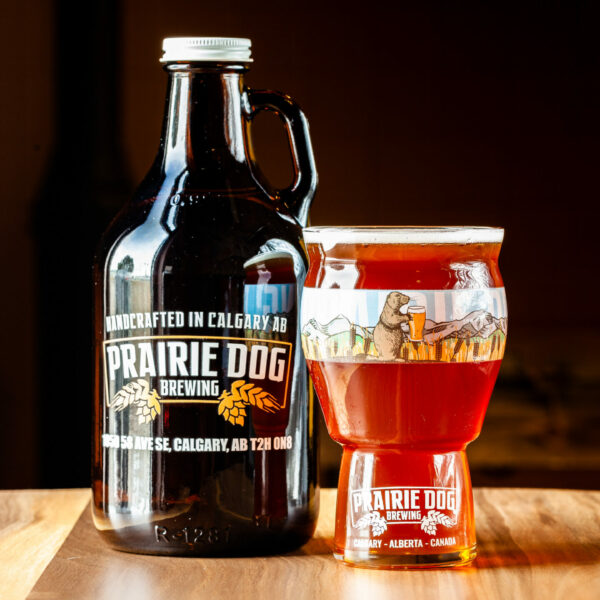 Prairie Dog Brewing's Prairie Lands Lager in a 946mL howler jug and 473mL draft pour.