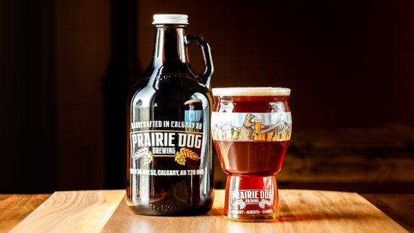 Prairie Dog Brewing's Supinator Doppelbock in a 946mL howler jug and 473mL draft pour.