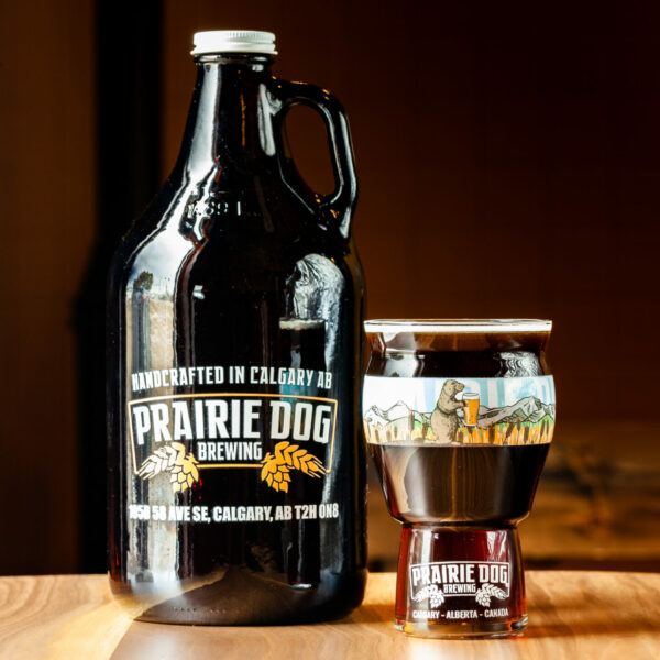 A 1.89L growler jug and 473mL draft pour of Prairie Dog Brewing's Gunnison's Red Ale.