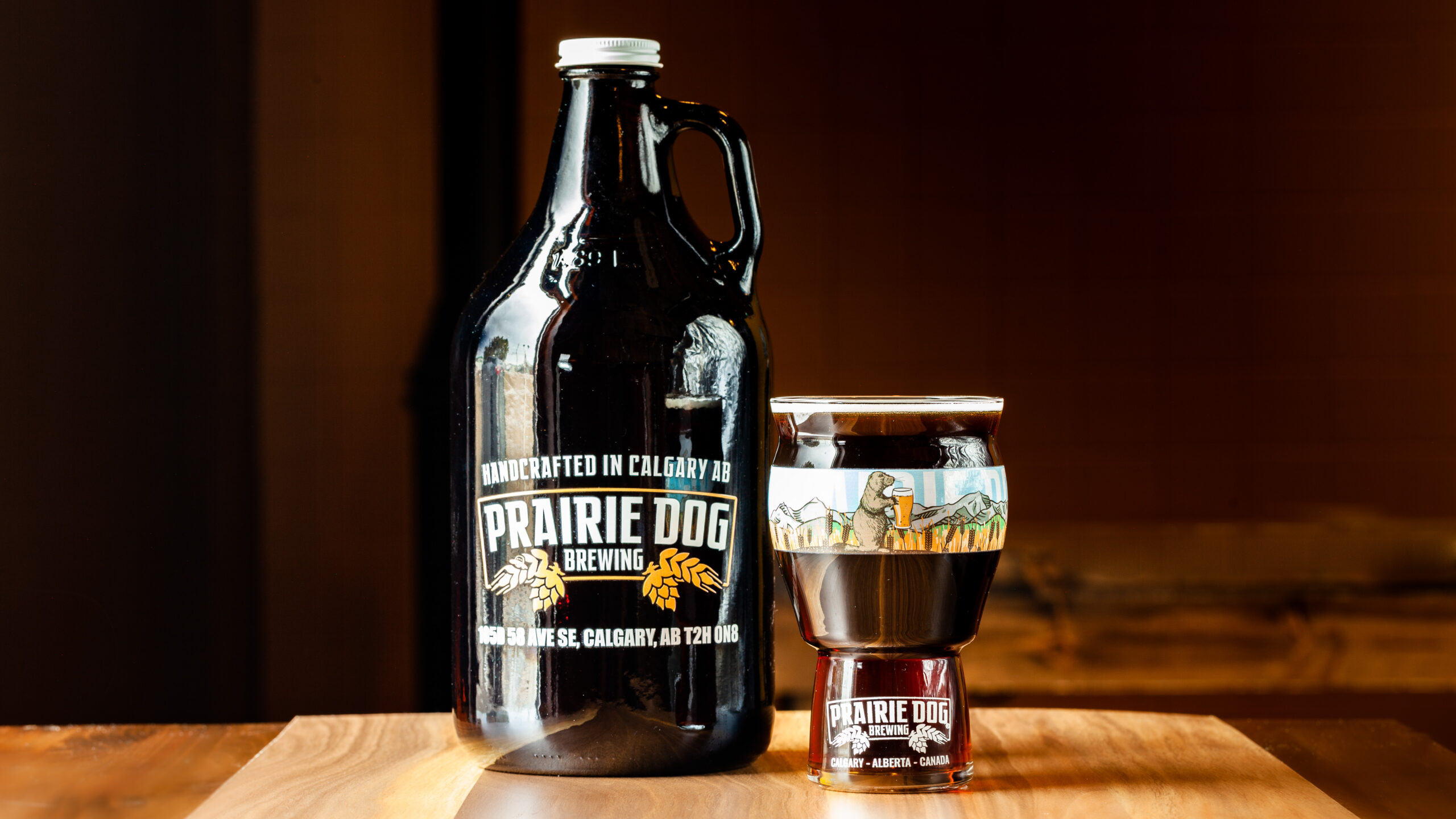 A 1.89L growler jug and 473mL draft pour of Prairie Dog Brewing's Gunnison's Red Ale.