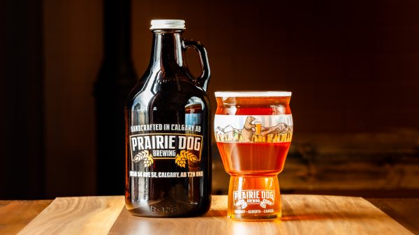 A 946mL howler jug and 473mL draft pour of Prairie Dog Brewing Boots Up Belgian-style IPA