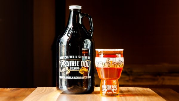 A 1.89L growler jug and 473mL draft pour of Prairie Dog Brewing Boots Up Belgian-style IPA
