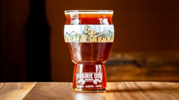 A 473-mL draft pour of Prairie Dog Brewing's Midnight Combine 2020 barrel-aged Belgian-style dark strong ale.