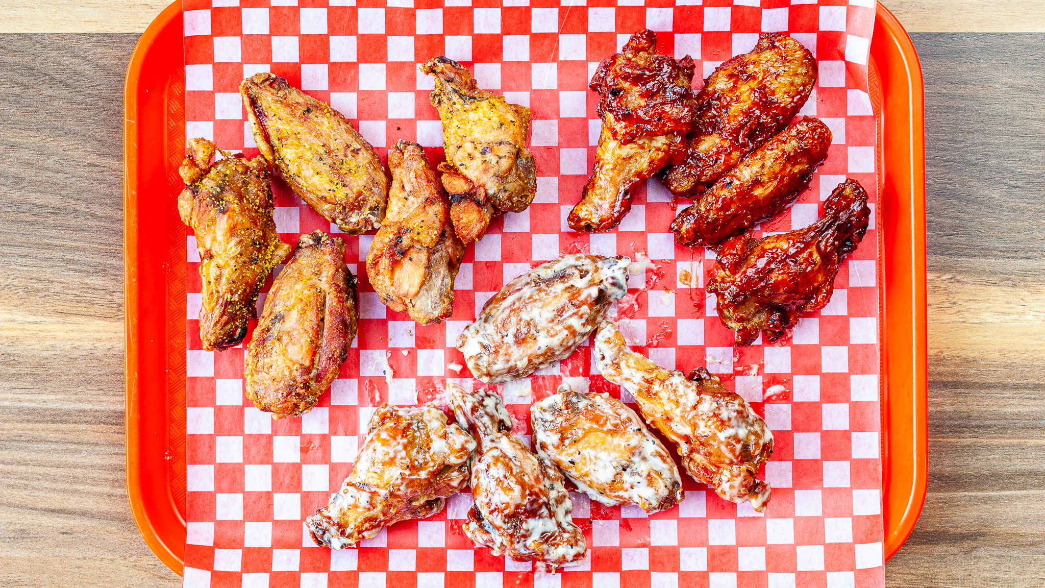 Prairie Dog Brewing's Smoked Chicken Wings - XL Size with 14 large, sauced or rubbed Canadian chicken wings, shown on a BBQ platter.
