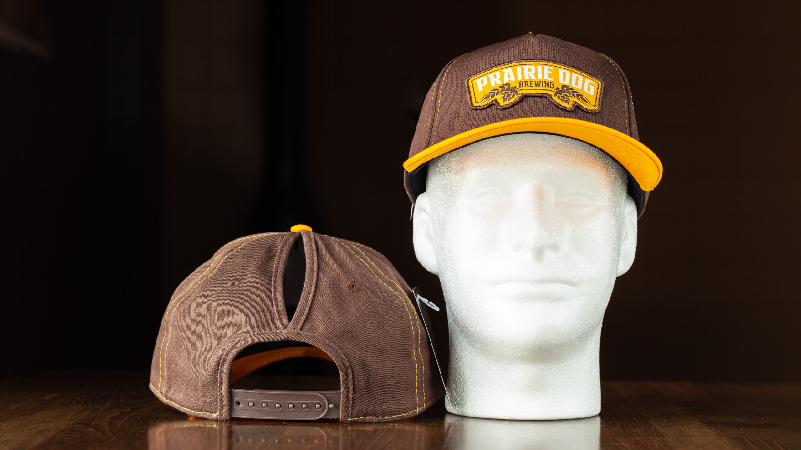 This Prairie Dog® Brewing hat is the perfect addition to any outfit. Prairie Dog Brewing brown and orange-yellow colours. The slogan gives a nod to your favourite local brewery and lets everyone know what you like. A high notch in the top of the hat allows for a high ponytail to come out the top of the hat.