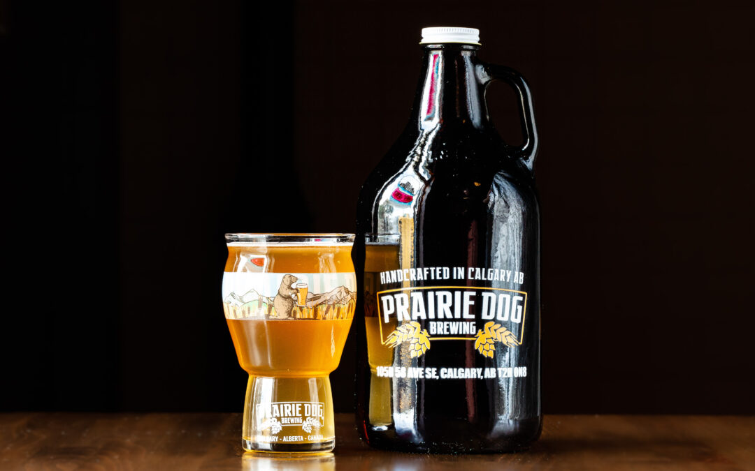 A 16oz 473mL Pint glass beside a 64oz 1.89L Growler Jug of Prairie Dog Brewing Jumpingpound Kettle Sour Beer