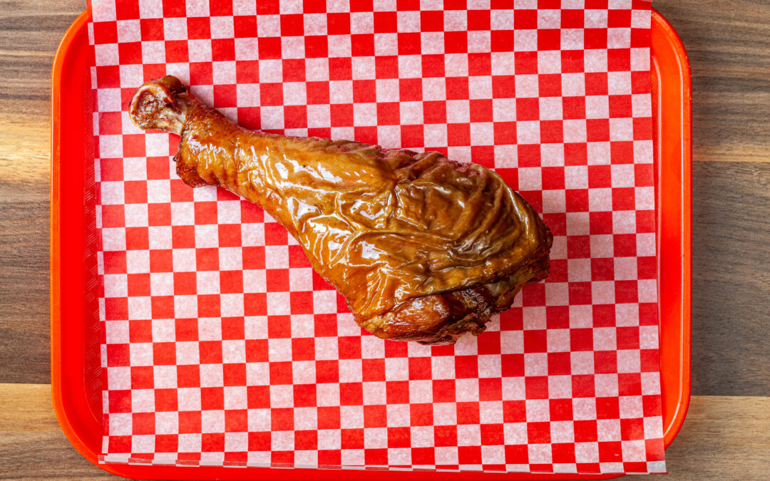 A cafeteria tray holding Prairie Dog Brewing's huge Smoked Turkey Leg, a special stampede inspired special that will fill up even the largest of appetites.