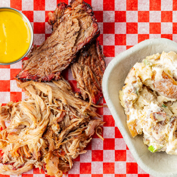 A top down view of Prairie Dog Brewing's Lunch Platter consisting of two meats, a side and one sauce.