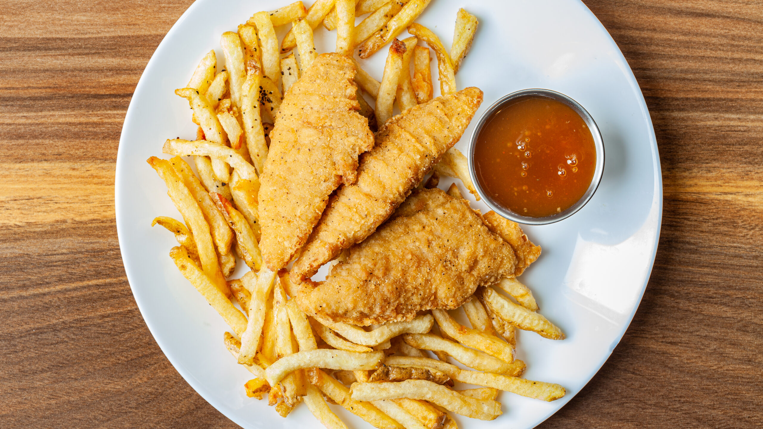 Kids' Chicken Tenders with Fries and Plum Sauce.