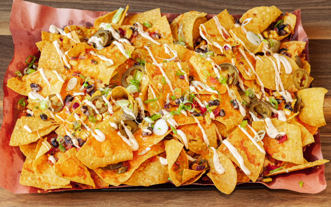 A large lined tray of Prairie Dog Brewing's Large Smoked Nachos, a part of the Summer Feature Menu for 2023.