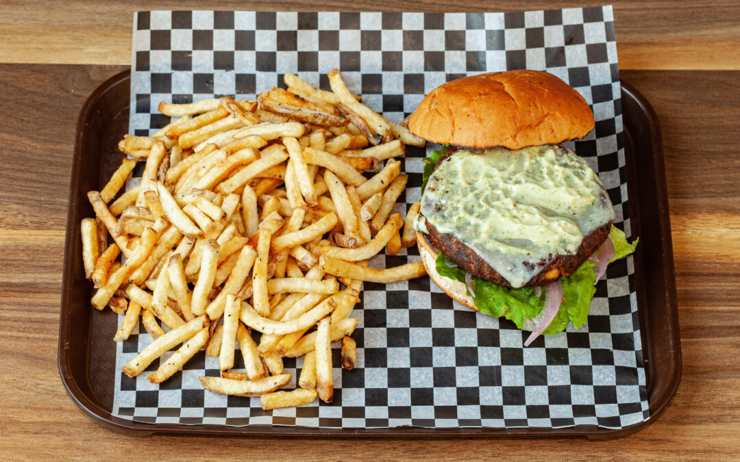A lined tray of Prairie Dog Brewing's Black Bean and Corn Burger, served with a side of Kennebec Fries. A part of the Summer Feature Menu for 2023.